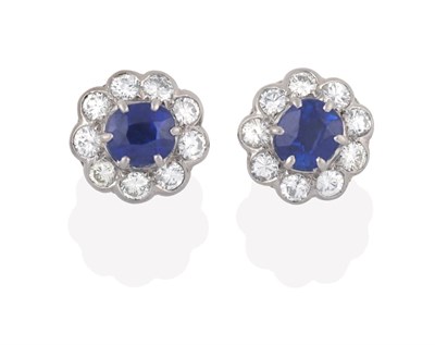 Lot 2187 - A Pair of Sapphire and Diamond Cluster Earrings, the oval cut sapphires within a border of...