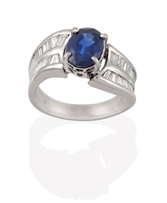 Lot 2193 - A Sapphire and Diamond Ring, the oval cut sapphire in a white four claw setting, to shoulders inset