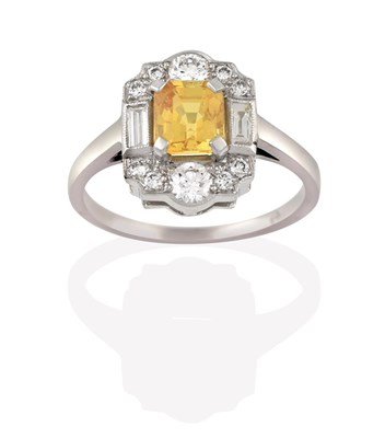 Lot 2194 - A Yellow Sapphire and Diamond Cluster Ring, the emerald-cut yellow sapphire within a border of...