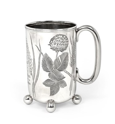 Lot 2302 - A Victorian Silver Mug, by Barker Brothers, Birmingham, 1895, cylindrical and on four ball...