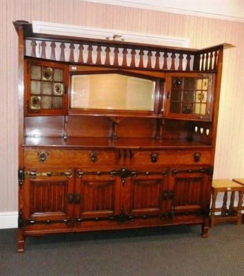 Lot 1722 - An Arts & Crafts Oak Buffet Sideboard, by Shapland & Petter of Barnstaple, the cornice above a...