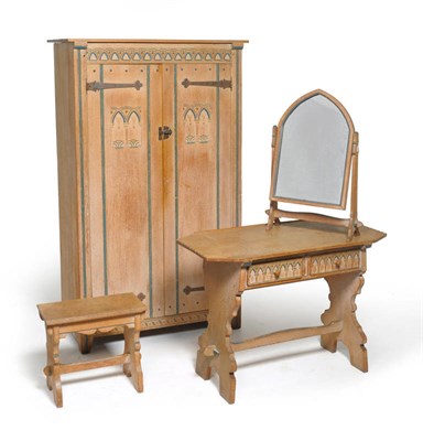 Lot 1723 - An Arts & Crafts Painted and Carved Oak Children's Bedroom Suite, the arched and reeded carving...