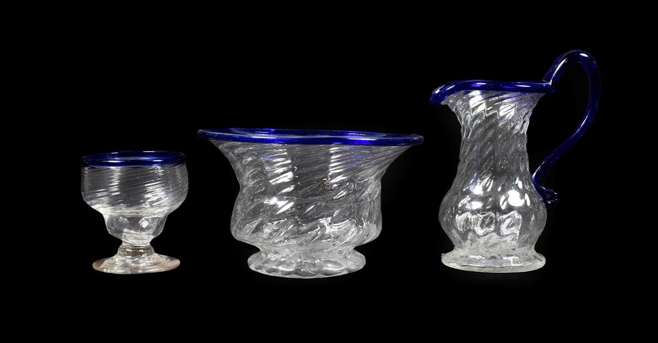 Lot 2 - A Matched Glass Cream Jug and Sugar Bowl, circa 1800, of wrythen fluted form with blue glass...