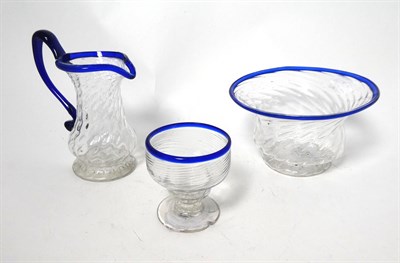 Lot 2 - A Matched Glass Cream Jug and Sugar Bowl, circa 1800, of wrythen fluted form with blue glass...