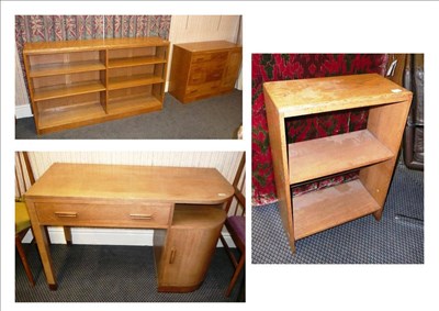 Lot 1733 - An Art Deco Oak Desk, with a single drawer and an open shelf above a shaped fitted cupboard...