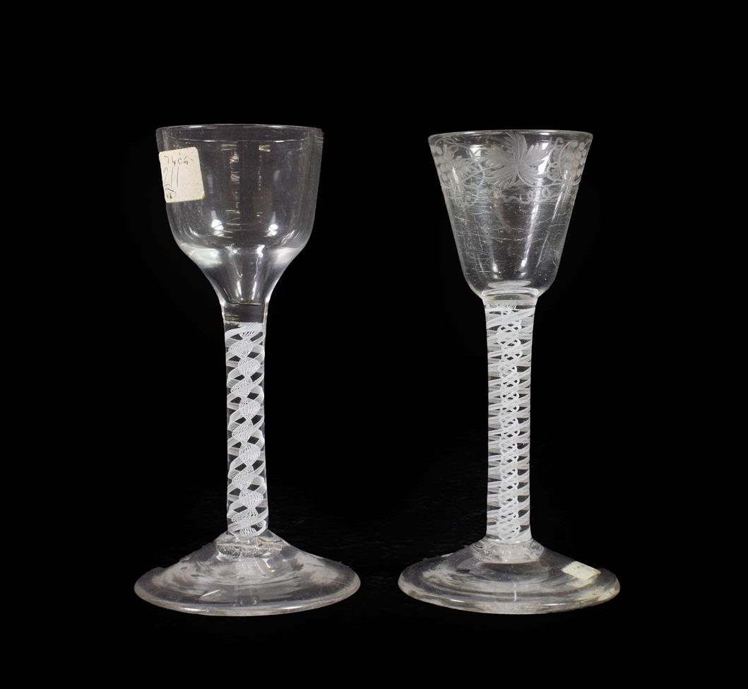 Lot 14 - A Wine Glass, circa 1750, the rounded funnel bowl engraved with fruiting vine on an opaque...