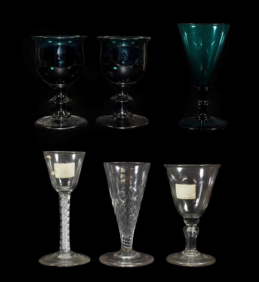 Lot 15 - A Pair of Green Glass Wine Glasses, early 19th century, the ovoid bowls with everted rims on...