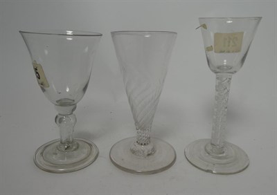 Lot 15 - A Pair of Green Glass Wine Glasses, early 19th century, the ovoid bowls with everted rims on...