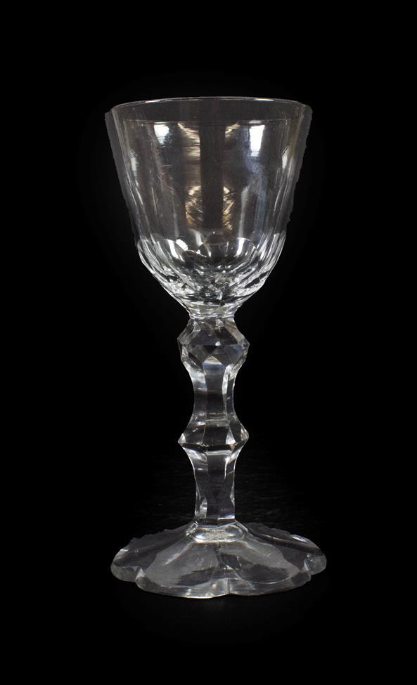 Lot 32 - A Wine Glass, circa 1780, the rounded funnel bowl with basal cutting on a faceted double...