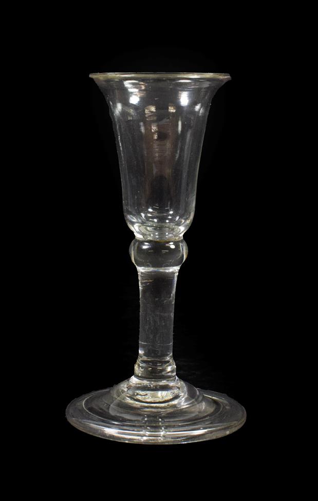 Lot 33 - A ''Gin'' Glass, circa 1760, the bell shaped bowl with basal ball knop on a plain stem and...