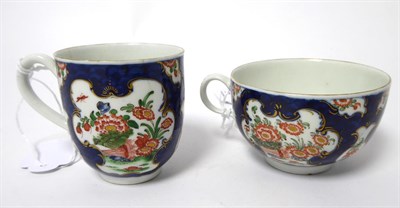 Lot 55 - A Worcester Porcelain Trio, circa 1770, painted with the Queen's Japan pattern on a blue scale...