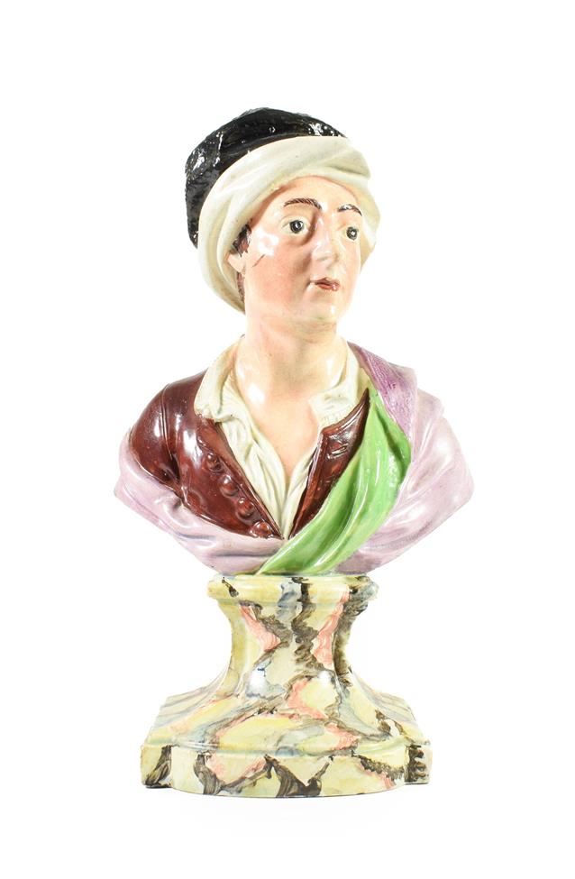 Lot 61 - A Pearlware Bust of Matthew Prior, circa 1800, naturalistically modelled wearing a black and...