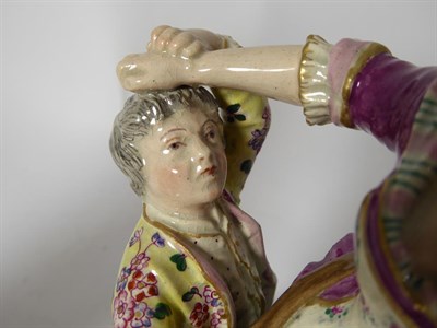 Lot 83 - A Pearlware Figure Group, circa 1810, in Meissen style, modelled as two boys trying to steal...