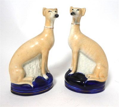 Lot 85 - A Pair of Staffordshire Pottery Pen Holders, late 19th century, modelled as recumbent greyhounds on