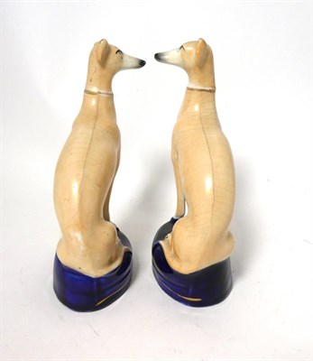 Lot 85 - A Pair of Staffordshire Pottery Pen Holders, late 19th century, modelled as recumbent greyhounds on