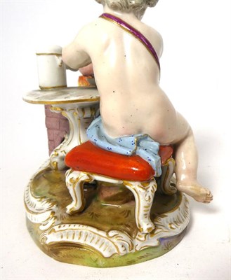 Lot 101 - A Meissen Porcelain Figure of a Cherub, late 19th/20th century, sitting at a tripod table with...
