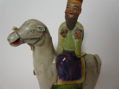 Lot 115 - A Chinese Porcelain Figure of a Sage, Qing Dynasty, possibly 18th century, on horseback, on a...