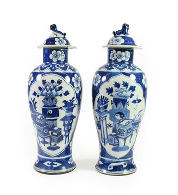 Lot 116 - A Pair of Chinese Porcelain Baluster Vases and Covers, Qianlong reign mark but circa 1900, with Dog
