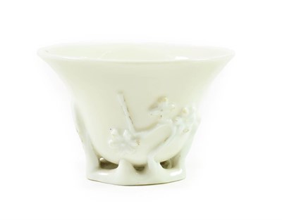 Lot 164 - A Chinese Blanc de Chine Libation Cup, 18th century, of ovoid form, moulded with prunus, 9.5cm...