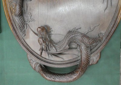 Lot 171 - A Chinese Huanghuali Tray, Qing Dynasty, of oval form, the handles carved as dragons, 70.5cm wide