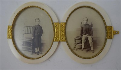 Lot 264 - A Gilt Metal Mounted Ivory Double Photograph Frame, circa 1880, of hinged oval form, 9.5cm...