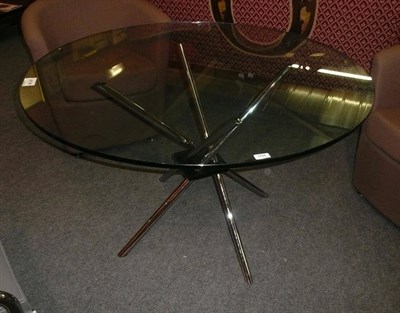 Lot 1759 - A Contemporary Table, with circular glass top, on four tubular legs, unmarked, 120cm diameter