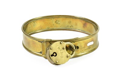 Lot 272 - A Brass Dog Collar, mid 19th century, with rolled edges and brass padlock inscribed MABIG, 11cm...