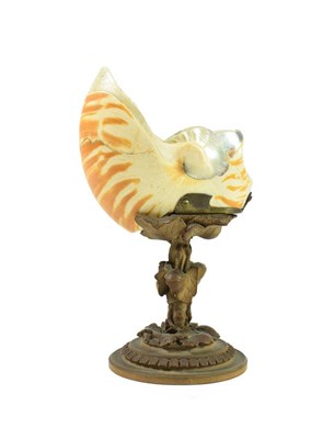 Lot 286 - A Boxwood Mounted Nautilus Shell, 19th century, carved with a hiding fish, on a foliate carved stem