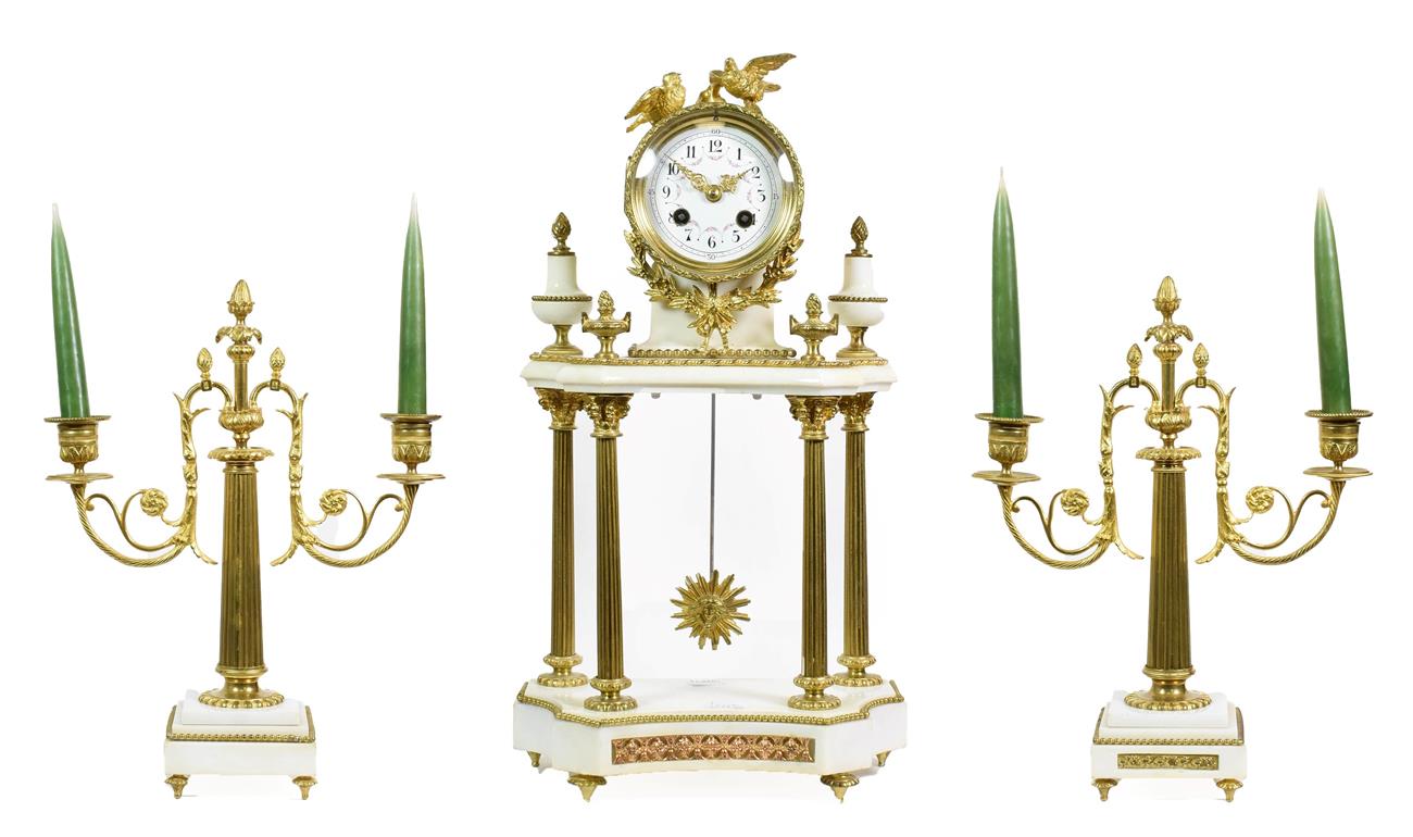 Lot 494 - A White Marble Portico Striking Mantel Clock with Garniture, early 20th century, surmounted by...