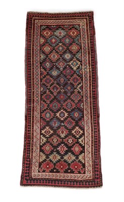 Lot 527 - North West Persian Runner, circa 1900 The field of polychrome serrated güls enclosed by ivory...