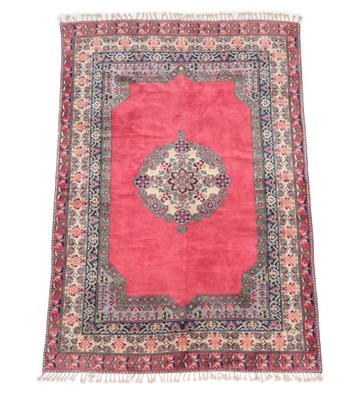Lot 534 - Berber Carpet North West Africa, circa 1970 The plain pale raspberry field centred by a...