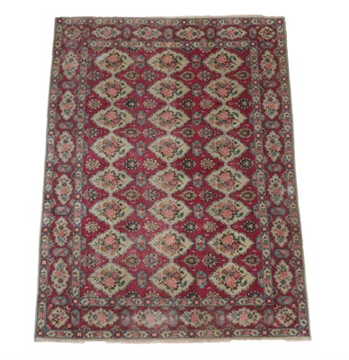 Lot 549 - Unusual Oriental Carpet Possibly Tabriz, circa 1950 The raspberry field with columns of diamond...