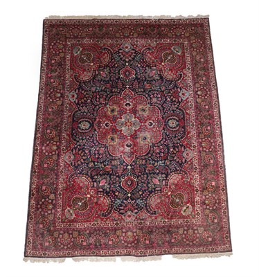 Lot 566 - Tabriz Carpet North West Iran, 20th century The indigo field of vines around a blood red...