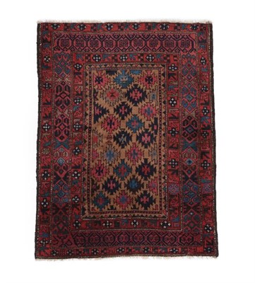 Lot 567 - Fine Baluch Rug Iranian/Afghan frontier, circa 1900 The natural camel field with a lattice of...