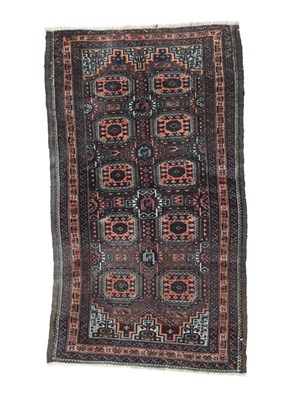 Lot 568 - Baluch Rug North East Iran, circa 1900 The chocolate brown field with two columns of Salor...
