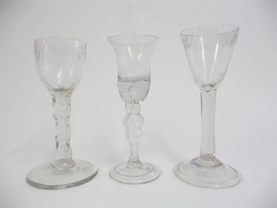 Lot 8 - A Wine Glass, 18th century, the bell shape bowl with basal air tear on hollow baluster stem and...