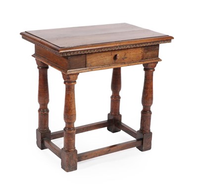 Lot 595 - A Walnut Side Table, the rectangular top above a nulled border and single frieze drawer, on gun...