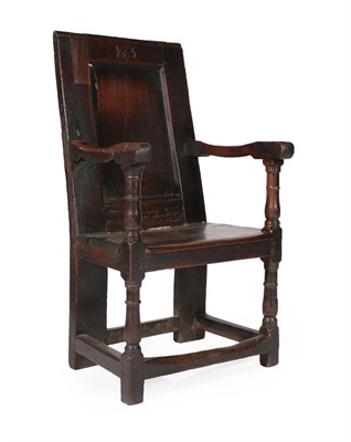 Lot 597 - A 17th Century Joined Oak Armchair, bearing date 1665, the back support with moulded panel...