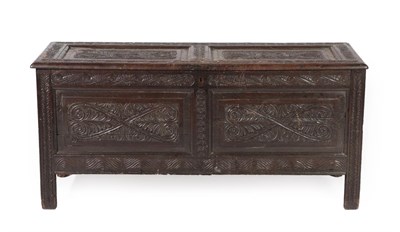 Lot 604 - A 17th Century Joined Oak Chest, the hinged lid carved overall with scrolled and S shape...