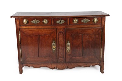Lot 606 - An Early 18th Century French Provincial Oak Sideboard, the three small drawers with brass knob...