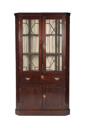 Lot 619 - A Mid 18th Century Oak Free-Standing Corner Cupboard, the moulded cornice above astragal glazed...