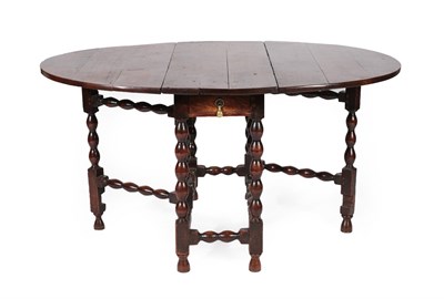 Lot 620 - An Early 18th Century Joined Oak Six-Seater Gateleg Dining Table, with oval drop leaves above a...