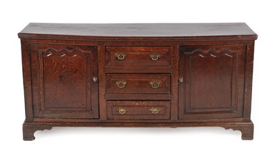 Lot 628 - An Early 18th Century Oak Enclosed Dresser Base, the moulded edge above a bank of three drawers...