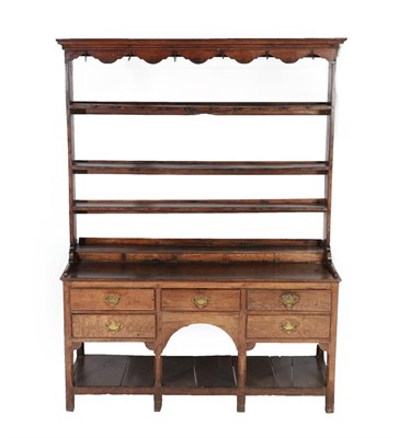Lot 630 - A George III Oak Open Dresser and Rack, late 18th century, the upper section with a wavy shaped...