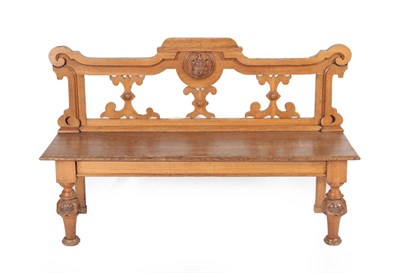 Lot 631 - A Victorian Oak Hall Bench, circa 1870, the scrolled back support centred by a crest of rampant...