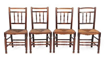 Lot 634 - A Set of Four Mid 19th Century Ash and Rush-Seated Spindle-Back Armchairs, with chamfered top rails