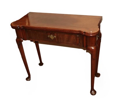 Lot 642 - A Mid 18th Century Red Walnut Foldover Tea Table, the eared corners above a frieze drawer, on...