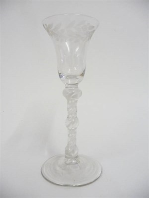 Lot 19 - A Wine Glass, circa 1765, the bell shaped bowl engraved with a leaf band on a double knopped opaque