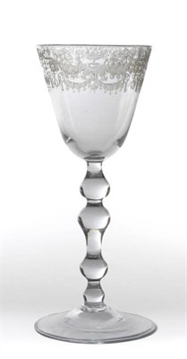 Lot 21 - A Light Baluster Wine Glass, circa 1750, the round funnel bowl engraved with birds and bowls of...