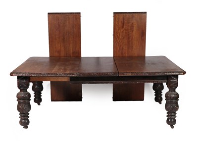 Lot 703 - A Victorian Carved Oak Wind-Out Dining Table, circa 1880, with three additional leaves, the...